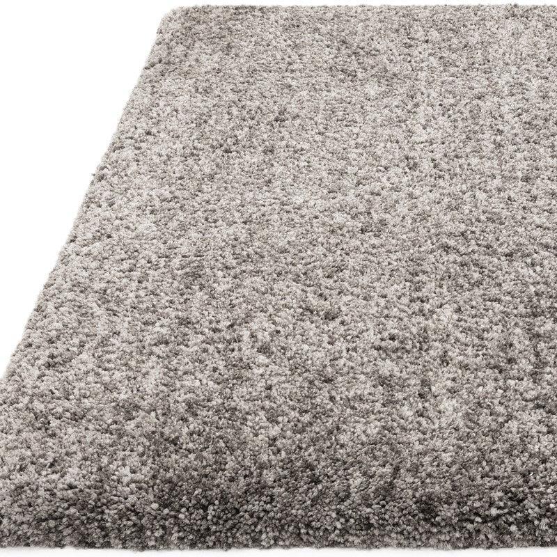 Light grey shaggy rug closeup showing soft textured pile and rectangular shape