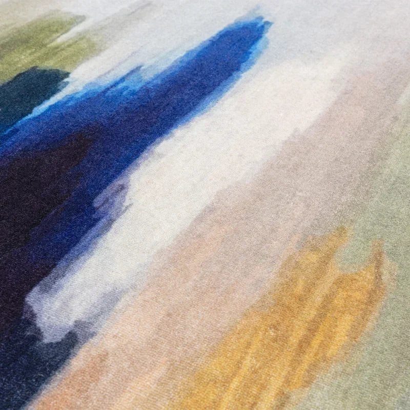 Abstract area rug with blue, green, yellow and beige brushstroke design