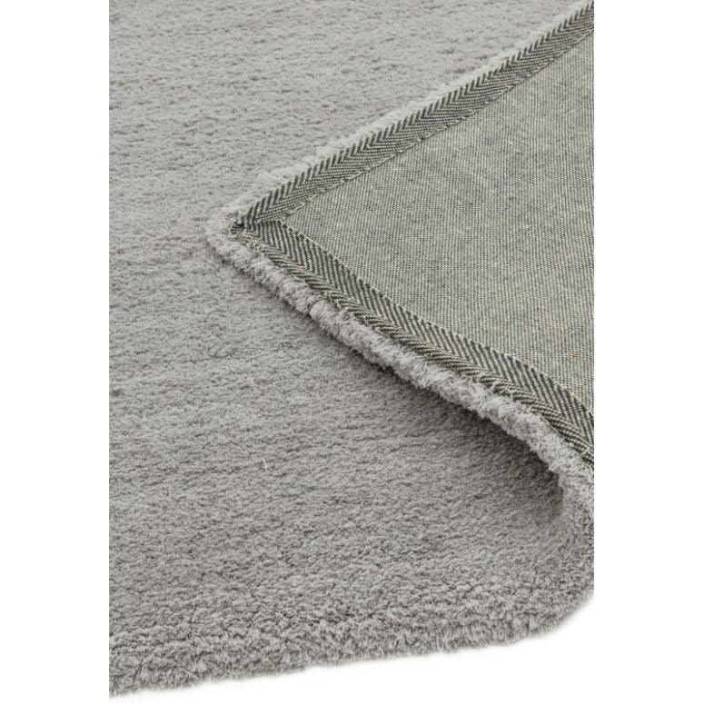 Light grey area rug with soft pile and detailed view of fabric backing