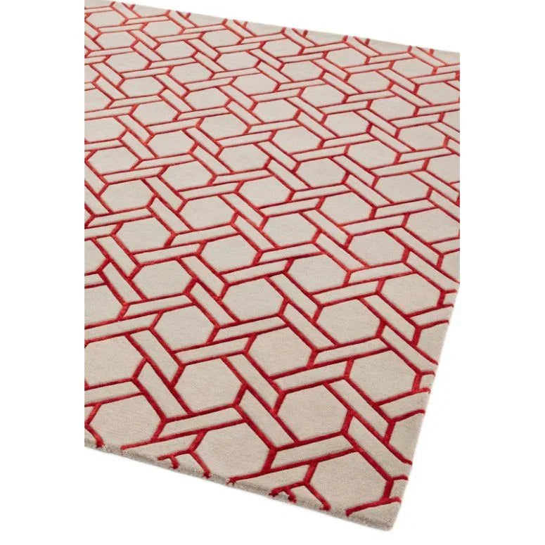 Beige area rug with red geometric pattern and textured surface, angled view