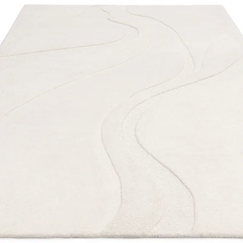 Ivory area rug with subtle raised wave pattern and soft texture