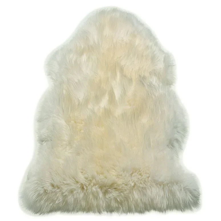 cream sheepskin rug with soft, fluffy texture on white background