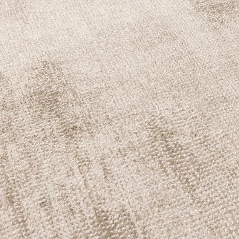 Close-up of beige textured area rug with soft pile and subtle pattern