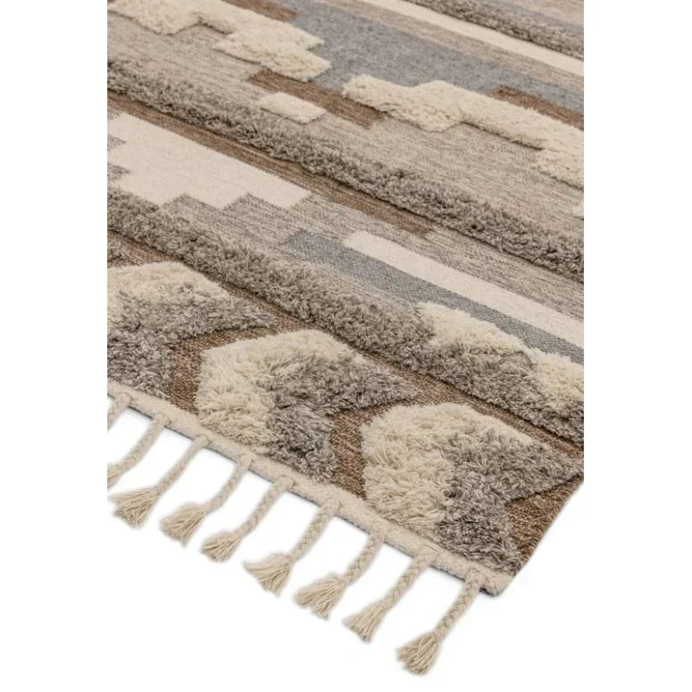 Neutral geometric pattern area rug with fringe, close-up showing textured detail