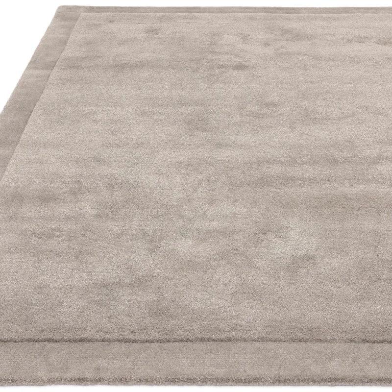 Light grey rectangular area rug with subtle border, soft carpet texture, top-down angle