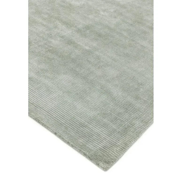 Light grey textured rug with subtle ribbed pattern, corner angle view