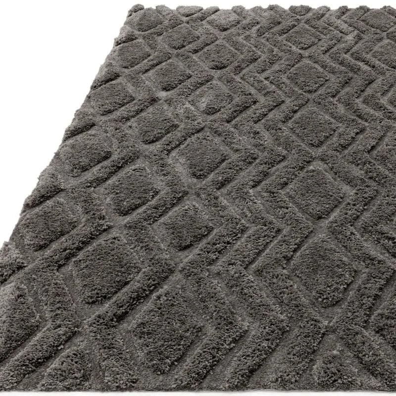 Grey shaggy rug with raised diamond pattern and soft textured finish