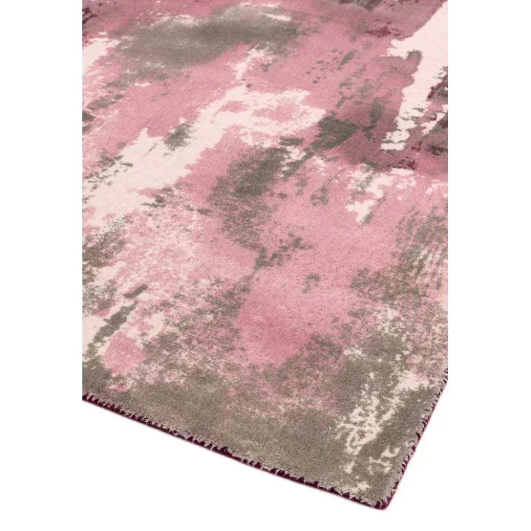Abstract pink and grey area rug with soft textured finish, corner angle view