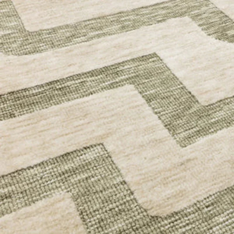 Beige and green geometric pattern rug close-up showing textured weave