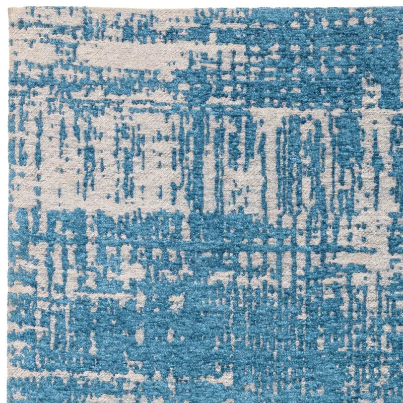 blue and cream abstract patterned area rug close up