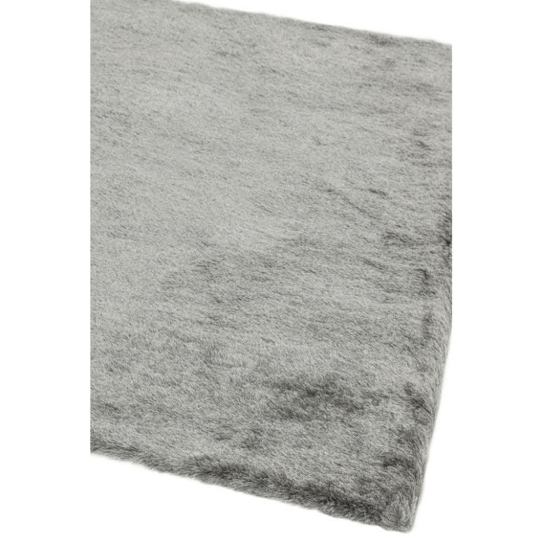 Close-up of grey shaggy rug corner with soft textured pile