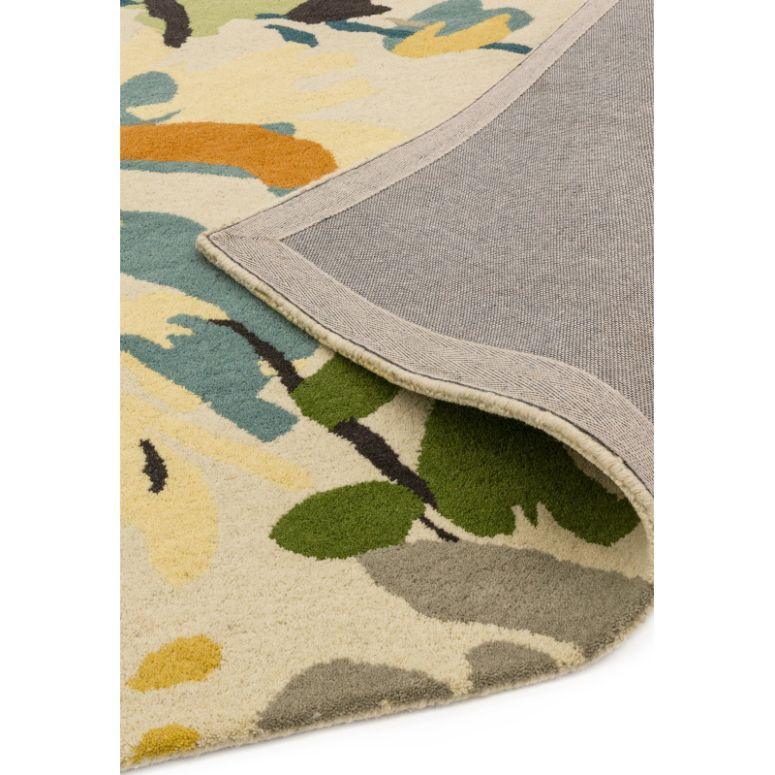 Multicolour abstract rug with corner flipped to show grey backing and soft pile