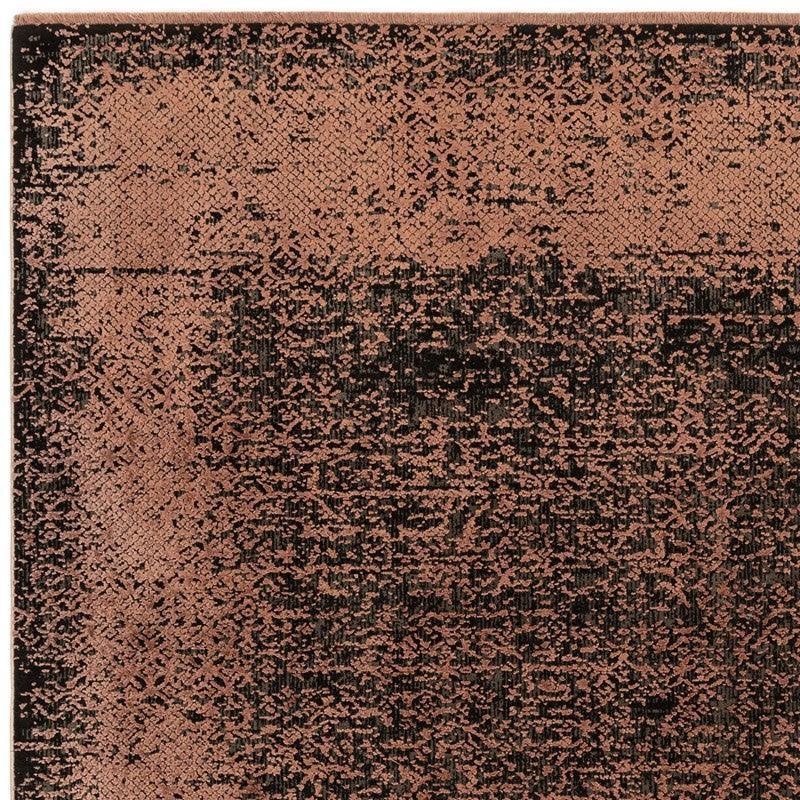 modern area rug with distressed pink and black pattern, close-up of corner texture