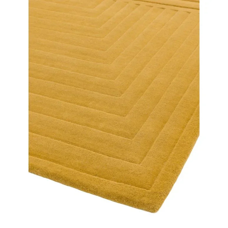 Yellow geometric wool rug with raised linear pattern, close-up of corner and texture detail