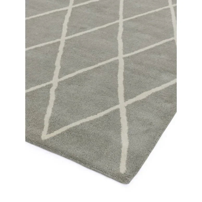 Grey area rug with white geometric lines and soft pile texture, corner angle view
