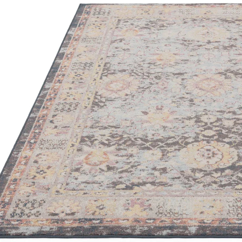 Vintage style area rug with faded floral pattern and soft pastel border