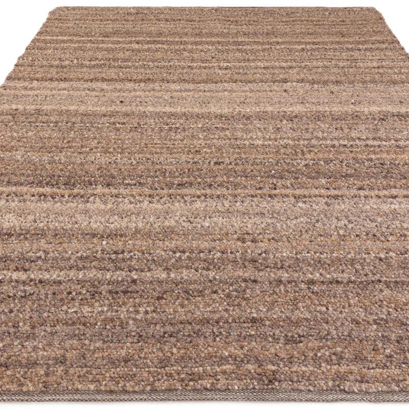 Beige textured area rug with horizontal stripes, shown from a low angle