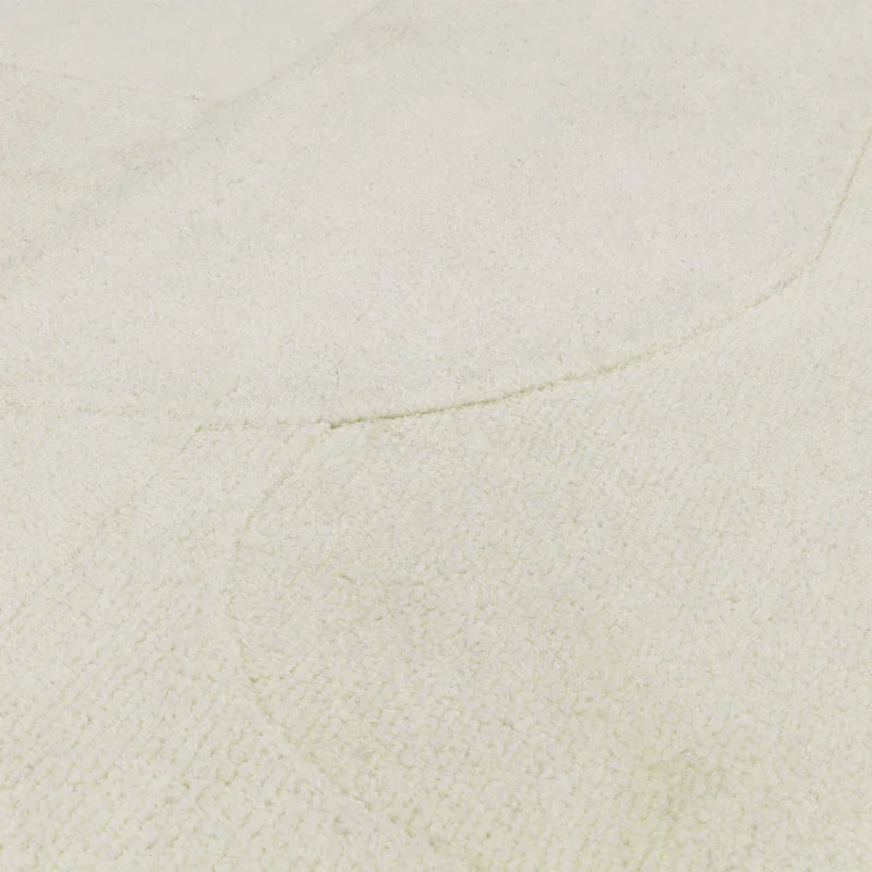 Close-up of cream textured rug surface with subtle geometric pattern