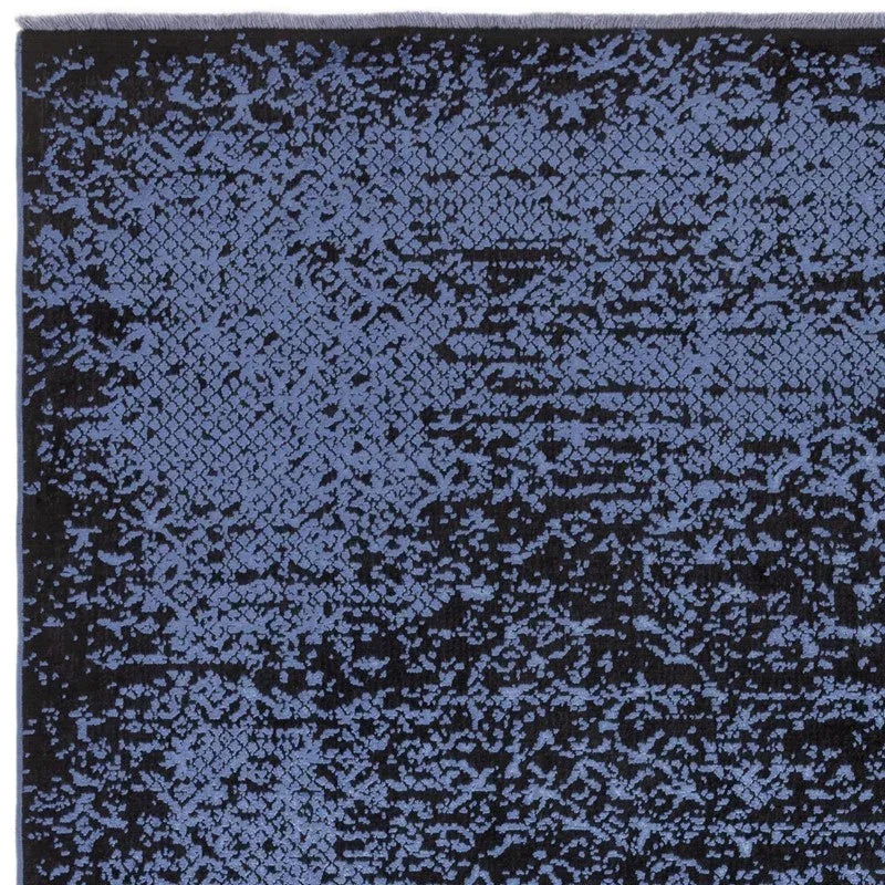 Blue and black patterned area rug with geometric and abstract design