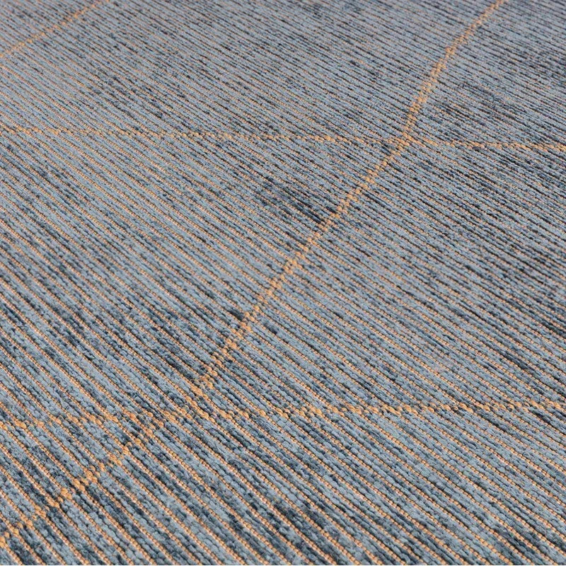 Blue and beige area rug with linear textured pattern and diagonal accent lines