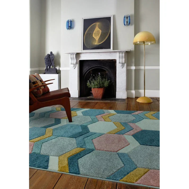 Hexagon geometric area rug in blue, green and yellow on hardwood floor in modern living room