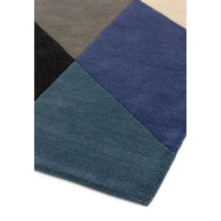 multicolour geometric rug close-up with blue, teal, grey and black sections