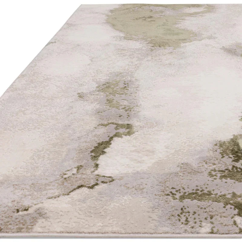 Abstract area rug with beige, cream and green pattern on a flat surface