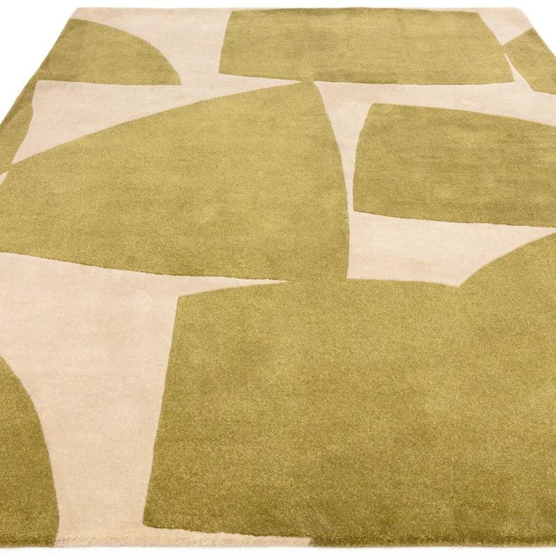 Green and cream abstract patterned area rug with geometric shapes