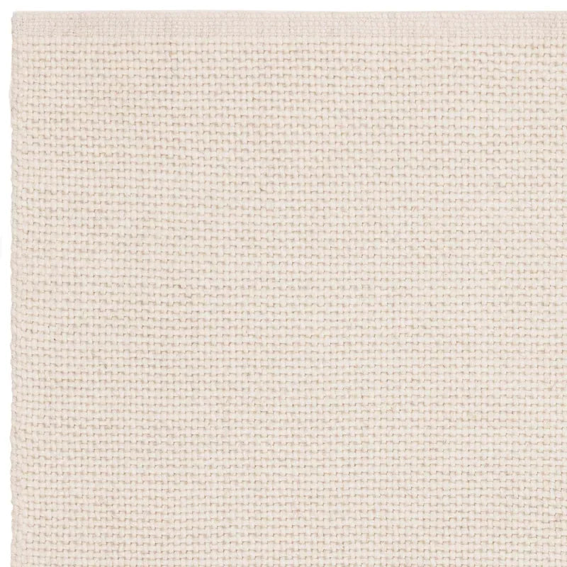 Closeup of cream woven rug texture with subtle grid pattern