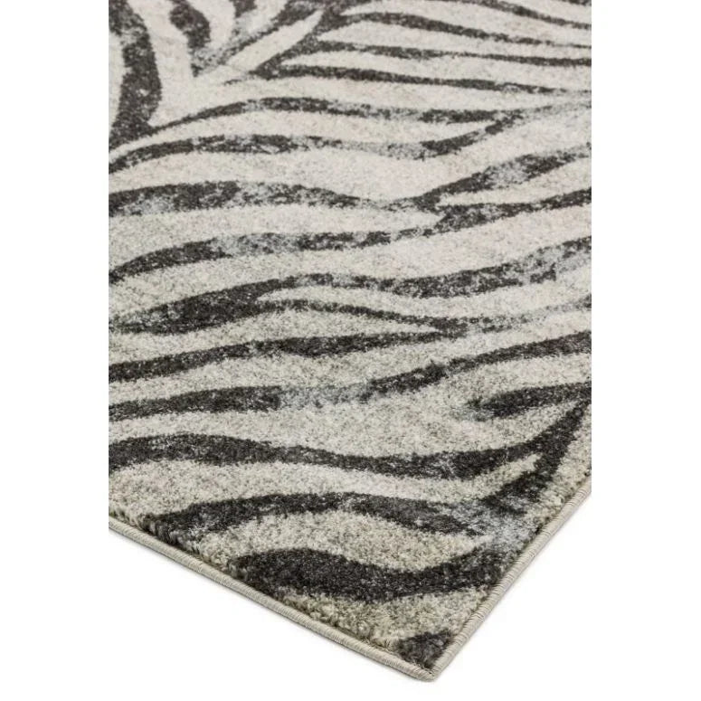 Grey and black zebra print rug corner close-up with textured pile
