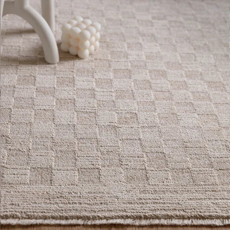 Beige textured rug with raised geometric pattern in living room setting