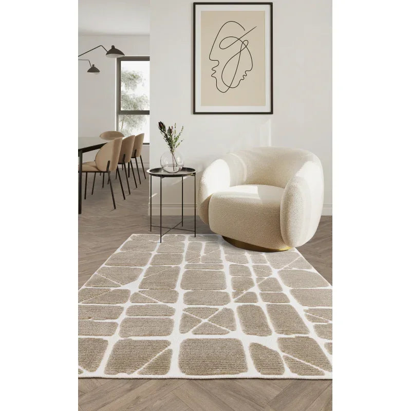 Beige geometric area rug in modern living room with boucle armchair and wall art