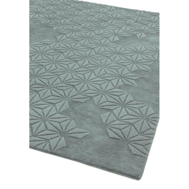 Grey patterned rug with geometric raised design viewed from an angle