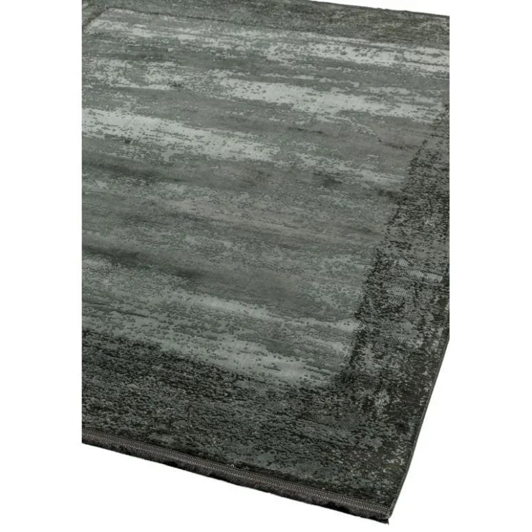 Corner of a modern grey area rug with textured pattern and soft finish