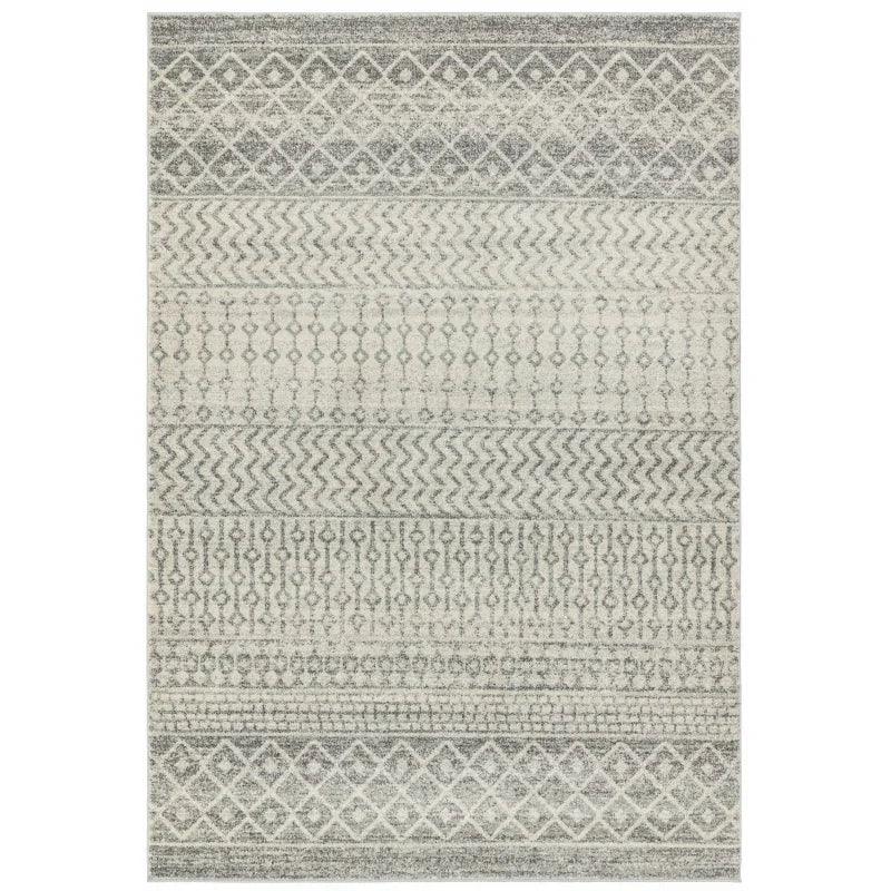Grey patterned area rug with geometric and zigzag designs, rectangular shape