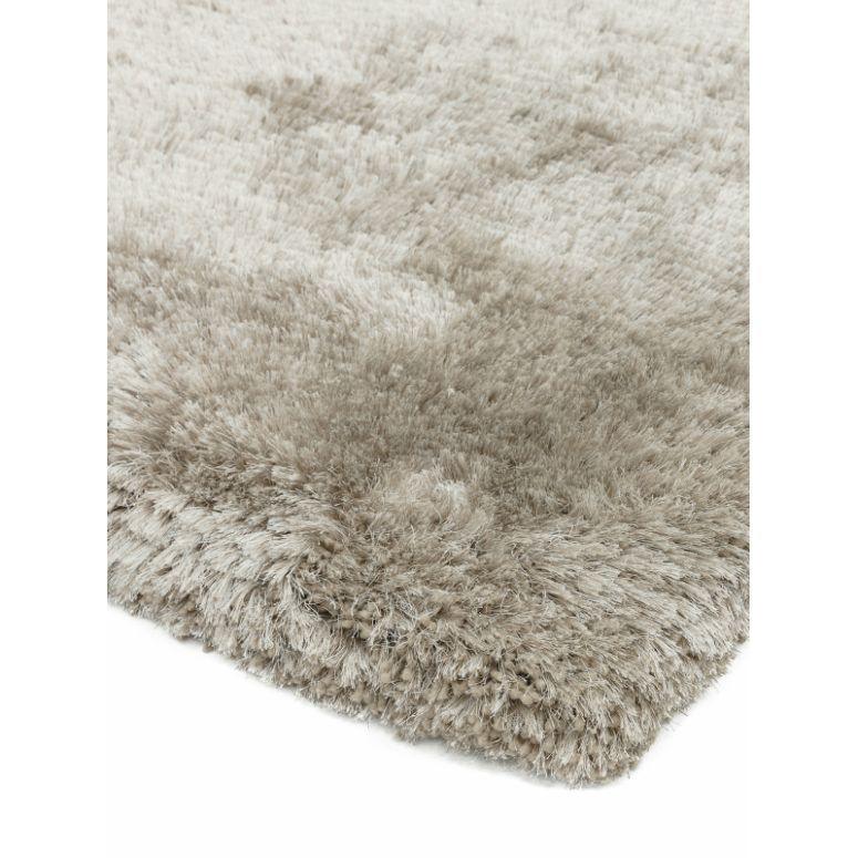 Close-up of beige shaggy rug with thick pile texture