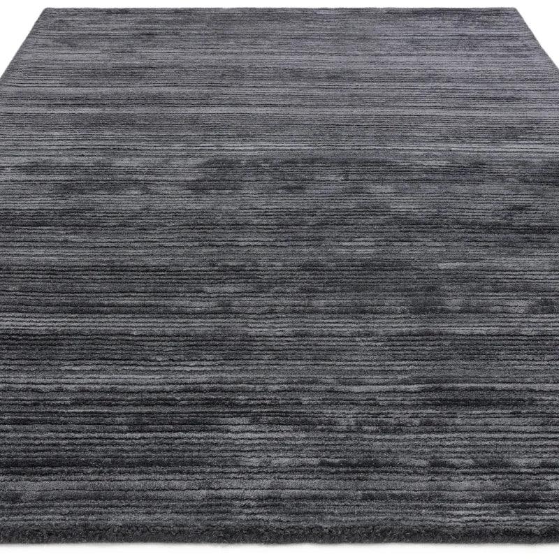 Charcoal grey striped area rug with textured surface and soft finish