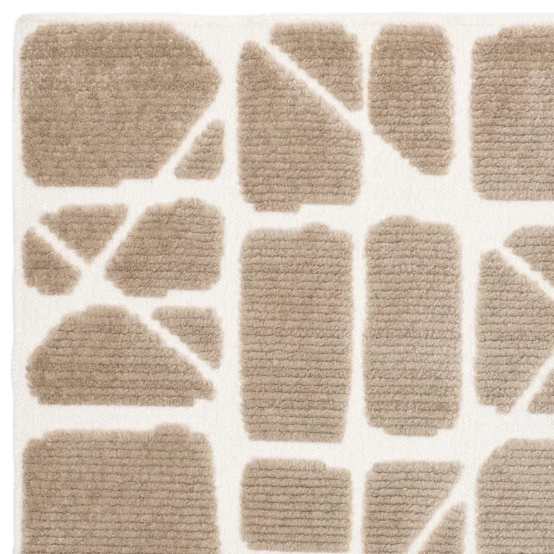 Beige modern rug with geometric pattern and textured pile on white background