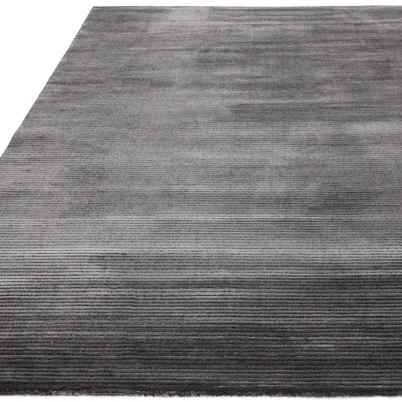 Large rectangular grey area rug with subtle linear texture and low pile