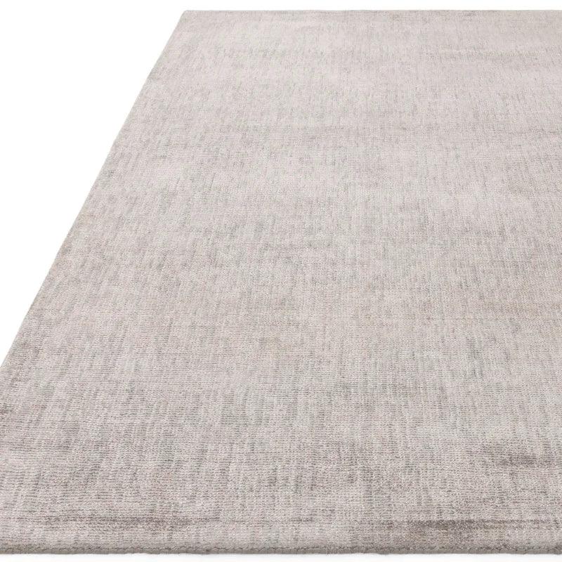 Large rectangular light grey rug with subtle textured pattern, viewed from close angle