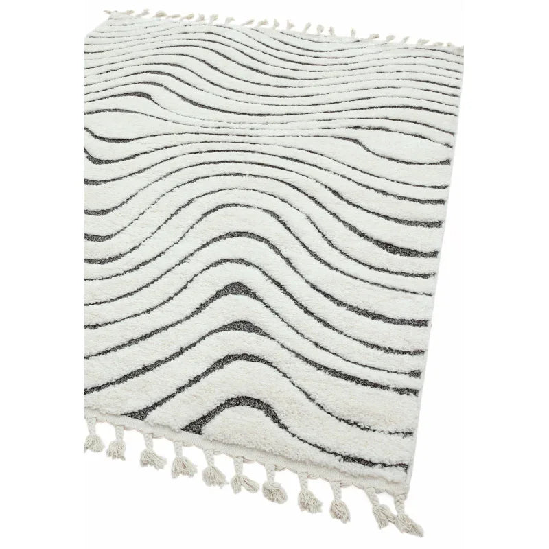 White area rug with wavy black lines and tasseled edges