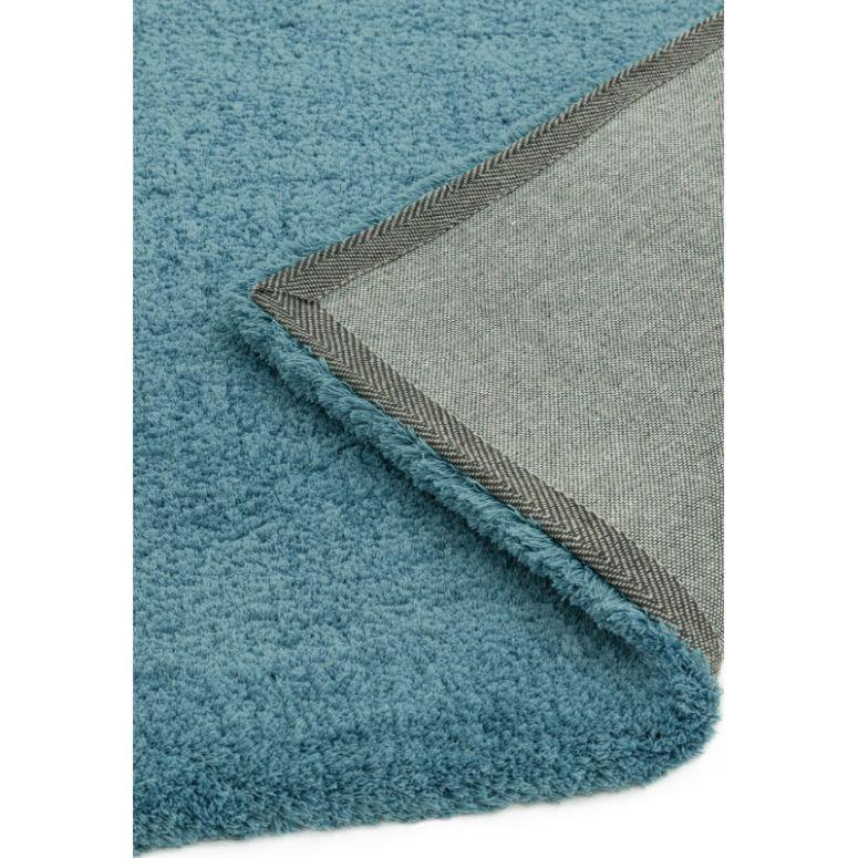 Blue textured rug with visible edge and non-slip grey backing corner