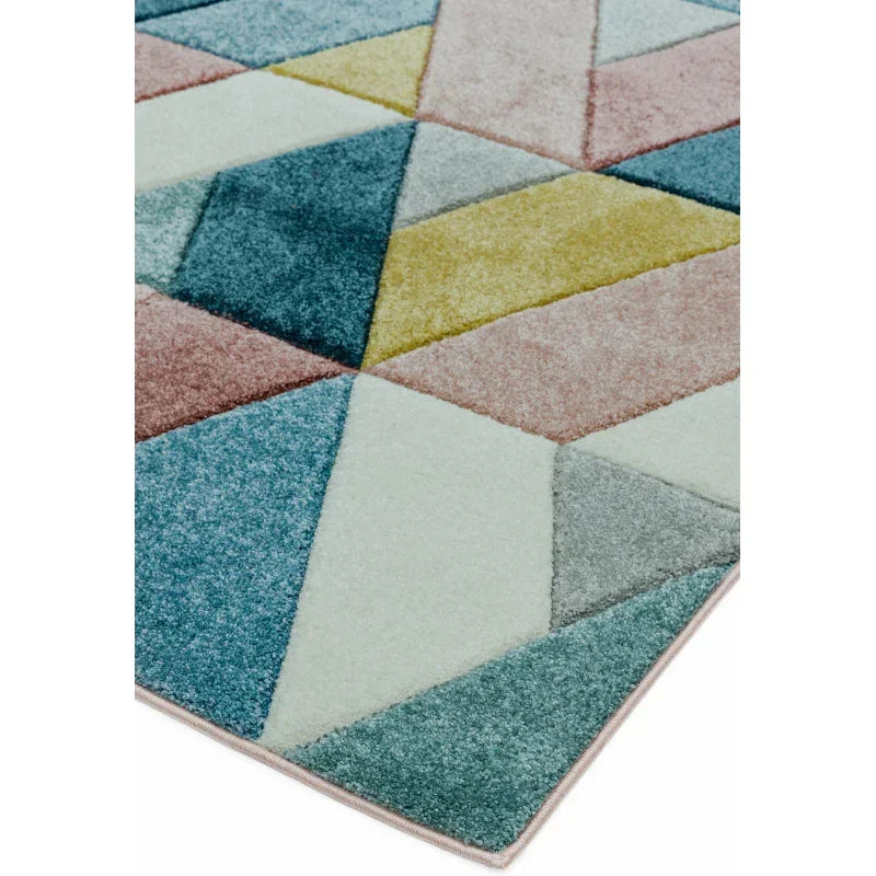 Multicolour geometric rug with blue, yellow, pink and grey pattern, close-up corner view