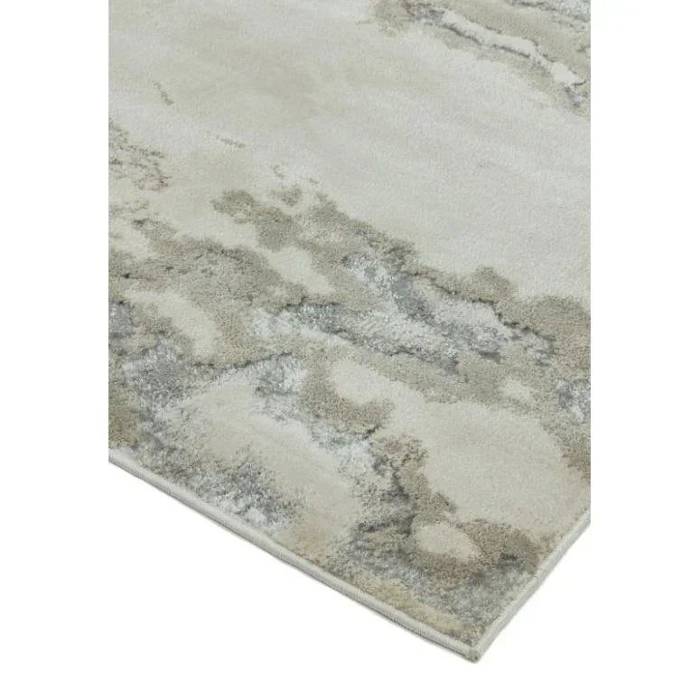 Abstract grey and cream area rug with soft textured pile, corner detail view