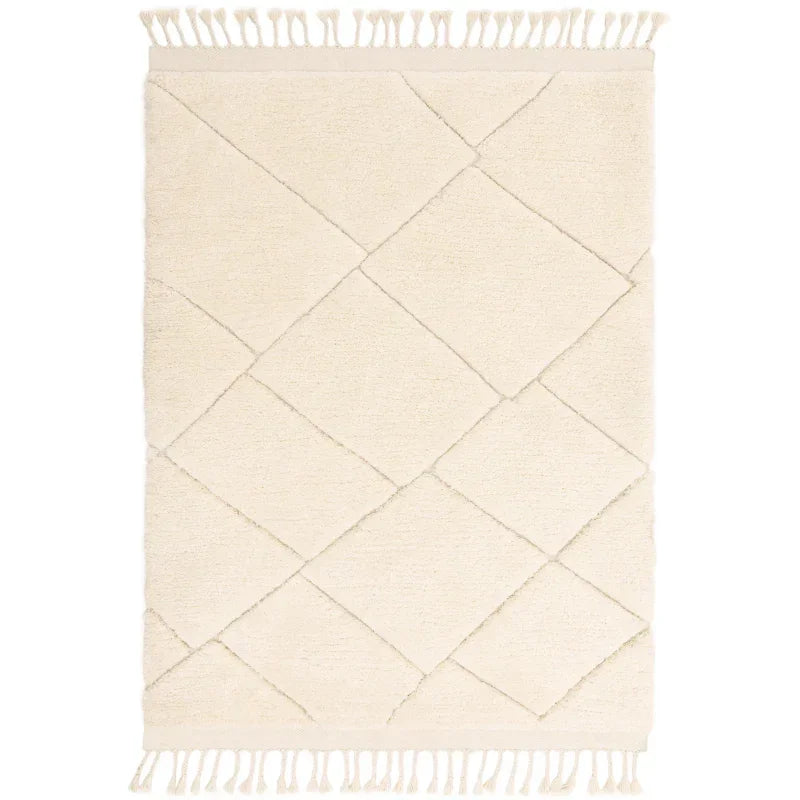 Cream geometric area rug with diamond pattern and fringed edges