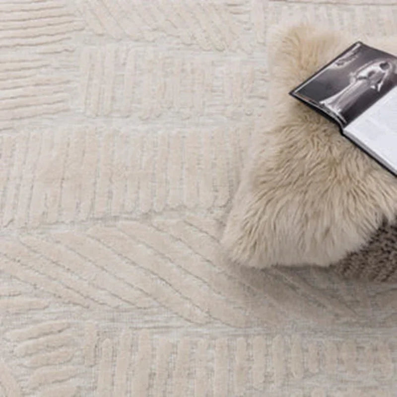 Textured cream rug with geometric pattern and fluffy cushion holding an open magazine