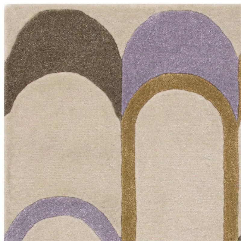 Abstract area rug with beige, brown, and purple arch design, close-up view