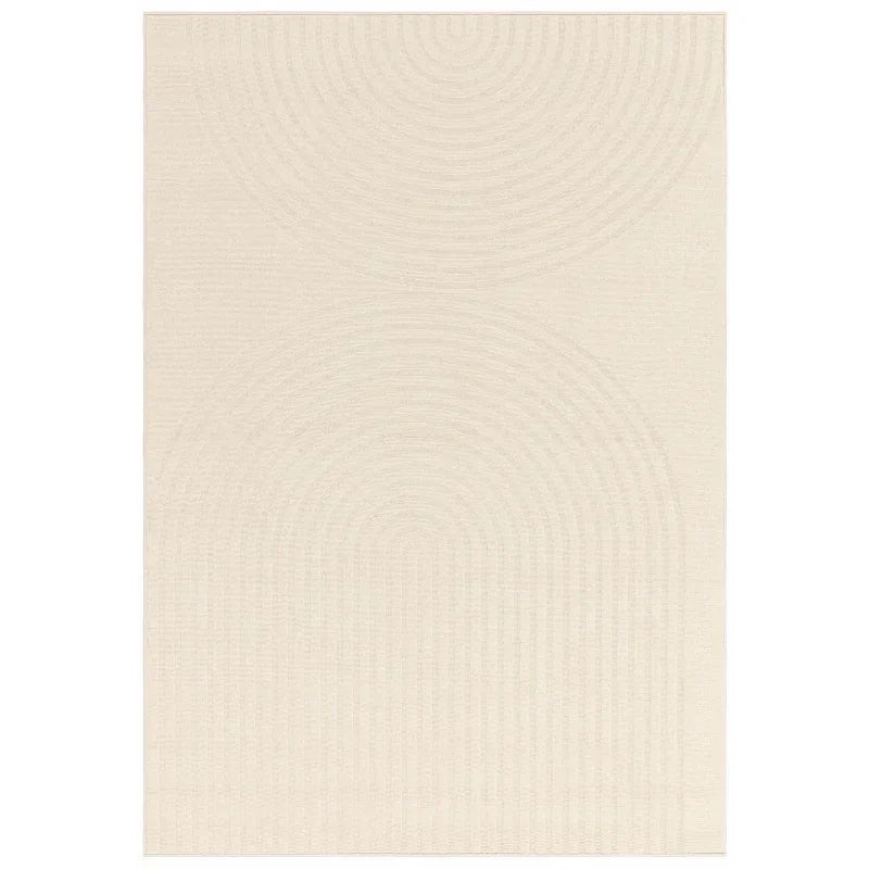 Cream area rug with subtle curved line pattern and textured geometric design