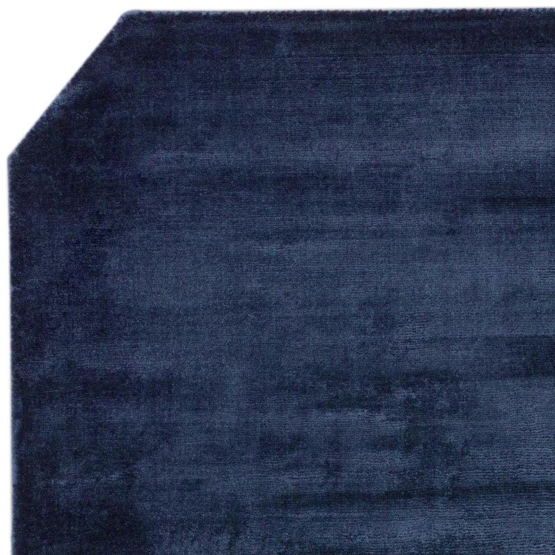 Navy blue area rug with cut corner detail and soft pile texture