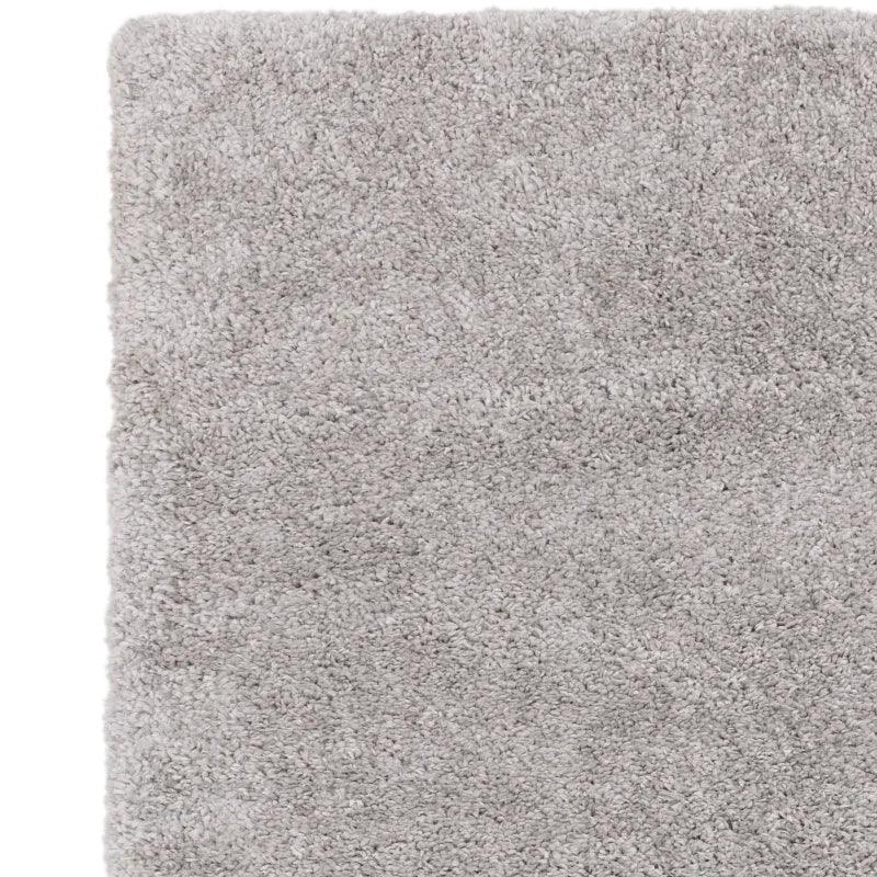 Close up of light grey shaggy rug with thick plush texture